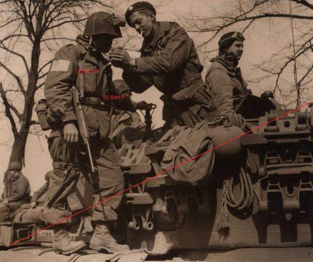 A 17th trooper getting a light from a British Guards Tank Crew Member....jpg